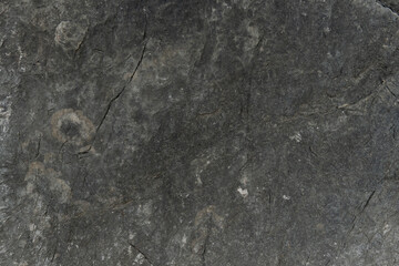 Naklejka premium Stone floor has a unique rough surface and dark color. For background and textured.