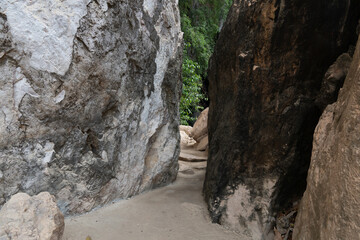Pathway in the rock. At Wat Tham Khao Bot Tample Wangchan Rayong Thailand. The path between the rocks.