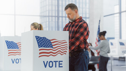 Democratic Process on Elections Day in the United States of America: Masculine Cowboy in Jeans and Checkered Shirt Casting His Vote in Private in Voting Booth and Putting His Ballot into a Sealed Box