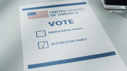 Elections Day: Paper Ballot Lying on a Desk in a Voting Booth with an American Flag and Democratic and Republican Candidates. Election in the United States of America. Voter Chose Republicans.