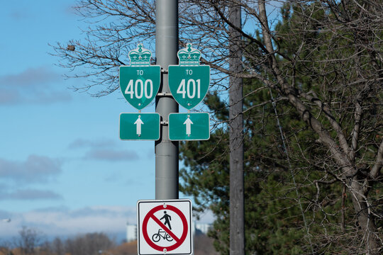 highway traffic signs on Black Creek Drive (for Highways 400 and 401) and a sign that prohibits pedestrians and cyclists from traveling alongside traffic