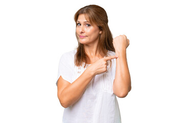 Middle-aged caucasian woman over isolated background making the gesture of being late