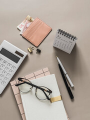 Planning, accounting of income expenses. Business finance concept. Accessories - planner, calculator, calendar on a light background, top view