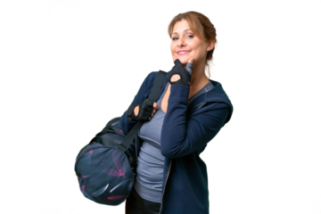 Middle-aged sport woman with sport bag over isolated background smiling