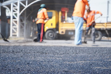 Blurred image of pavement maintenance work using human labor