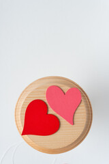 red and pink hearts on a wooden roundel close-up