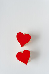 two red hearts on wooden objects