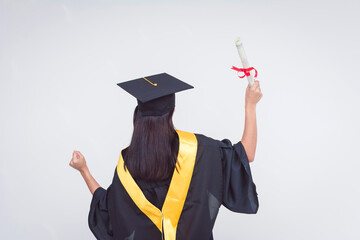 Back view of an upbeat and vivacious female graduate celebrating her diploma of bachelor of science. Feeling triumphant. Isolated on a white background.