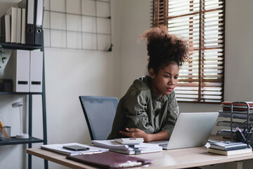 African american businesswoman reads finance data on laptop to thinking about strategy of business