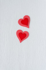 red on pink wooden heart embellishments and textured paper