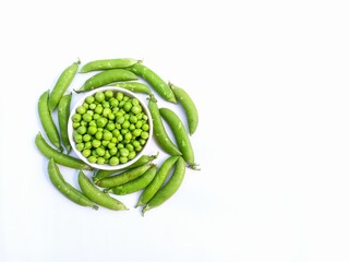 Fresh green pea seeds with peas pods isolated on white background