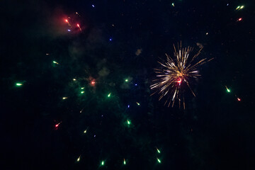 Burst of multicolored fireworks at night - vibrant streaks and sparks - smoke clouds - celebration, new years day, fourth of july, canada day. Taken in Toronto, Canada.