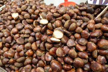 A large amount of raw chestnuts on the chestnut seller's counter,