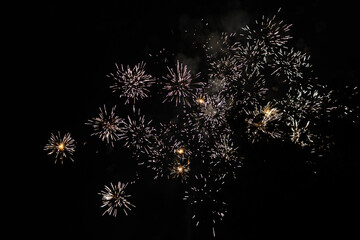 Bursts of white and yellow fireworks at night - vibrant streaks and sparks - smoke clouds - celebration, new years day, fourth of july, canada day. Taken in Toronto, Canada.