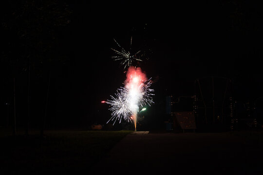 Burst of multicolor ground fireworks at night - vibrant streaks and sparks - smoke clouds - celebration, new years day, fourth of july, canada day. Taken in Toronto, Canada.