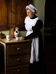 Victorian kitchen maid making tea