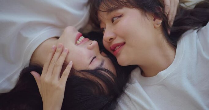 Happiness moment, Young lesbian couple with happy expression in bedroom at home. They enjoying together with this moment.