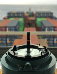 Closeup view of compass with azimuth circle fitted in the bridge of a merchant ship at sea