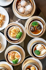 The Chinese food ,A many kind of Dim Sum in bamboo basket on table in chinese food restaurant.