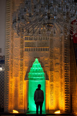 Silhouette shot of a Muslim praying inside the mosque,