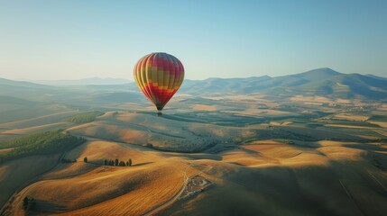 Obraz premium Hot Air Balloon Soaring Above a Vibrant Green Field, Summer Day