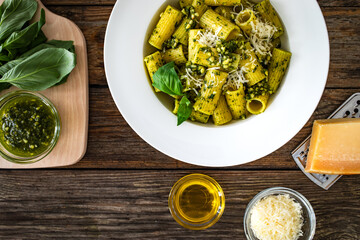 Pasta with basil pesto sauce on wooden table
