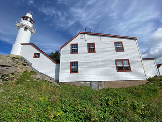 Lobster Cove Head Lighthouse at Gros Morne National Park in Newfoundland, Canada. Overlooking the...