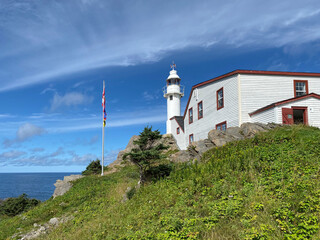 Fototapeta na wymiar Lobster Cove Head Lighthouse at Gros Morne National Park in Newfoundland, Canada. Overlooking the Gulf of St Lawrence, Bonne Bay and Rocky Harbor. Visitor center with cultural and historical exhibits 