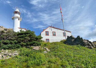 Fototapeta na wymiar Lobster Cove Head Lighthouse at Gros Morne National Park in Newfoundland, Canada. Overlooking the Gulf of St Lawrence, Bonne Bay and Rocky Harbor. Visitor center with cultural and historical exhibits 