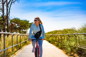 Mid adult woman riding bicycle at seaside  © Jacek Chabraszewski