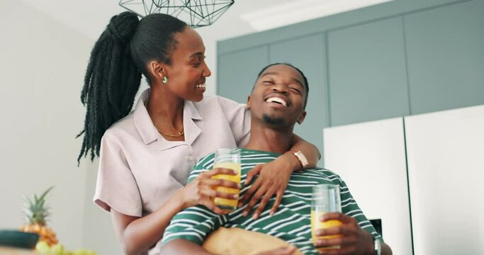 Black couple, kitchen and drinking at breakfast in a home with love, smile and bonding with food. Happy, support and marriage with trust and relax from cooking with juice and fruit at morning