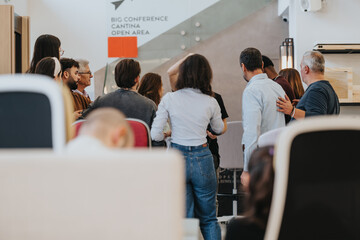 Diverse group of professionals gathering in modern office space.