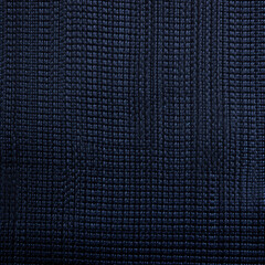 Close-up texture of a dark blue braided fabric with a detailed weave pattern