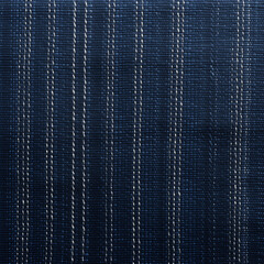 Close-up texture of a dark blue braided fabric with a detailed weave pattern