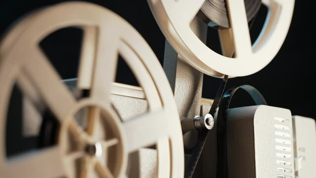 White film reels rotating. Old-fashioned 8mm movie projector playing bobbin tape