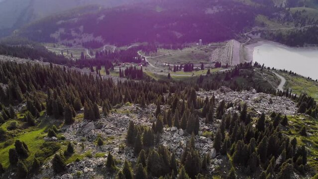 Top view of the Big Almaty Lake dam. The water in the lake is cloudy due to the active melting of glaciers in the summer