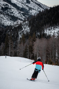 skier on a ski slope during a sunset with colorful sky