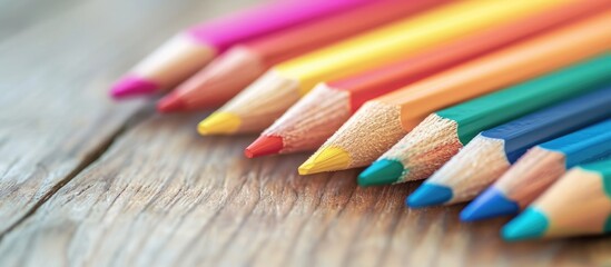 Pastel color pencils on a wooden desk convey a Back to School message for education or school.