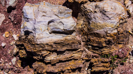 Red stones, blue sky, green water