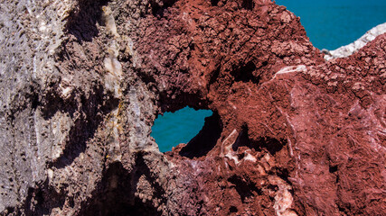 Red stones, blue sky, green water