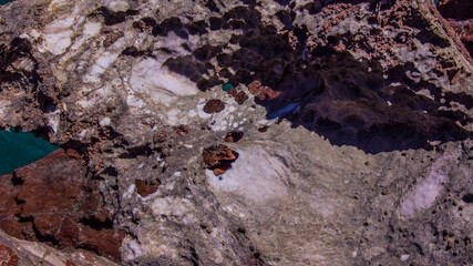 Red stones, blue sky, green water
