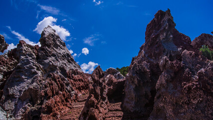 Red stones, blue sky, green water