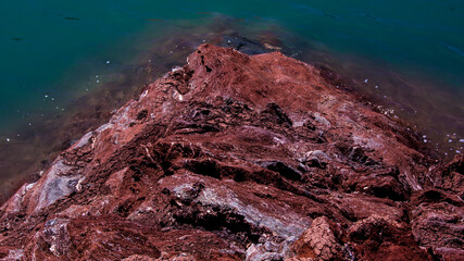 Red stones, blue sky, green water