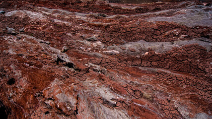 Red stones, blue sky, green water