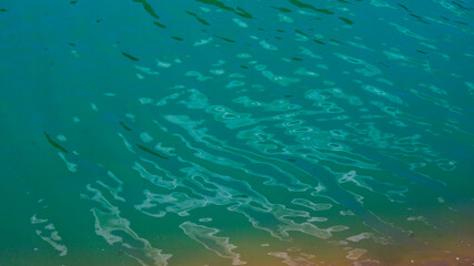 Red stones, blue sky, green water