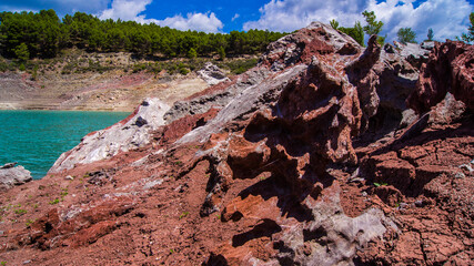 Red stones, blue sky, green water