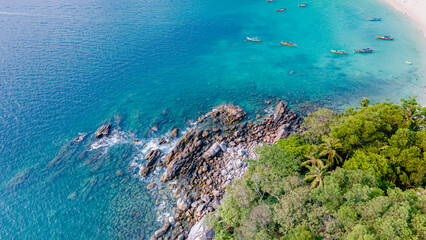 Paradise beach Phuket Patong. aerial top view amazing freedom beach small white sand beach with perfect nature. white wave hit the rock around island. green forest peaceful. green sea, landscape.