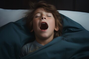 cold tones, boy in t shirt lied in bed under blanket and yawns with wide opened mouth and squint eyes