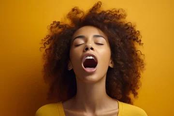 Fotobehang extremely whim Upset black curly haired young girl screaming and crying with opened mouth and closed eyes against color wall © useful pictures