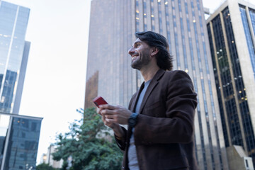 View of young man using a smartphone at twilight